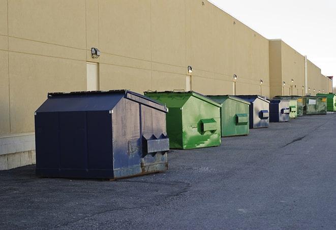 construction dumpsters on a worksite surrounded by caution tape in Gray